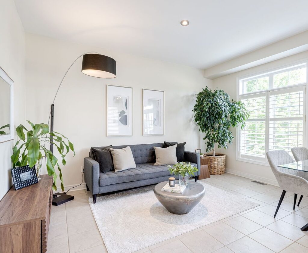 Occupied family room and dining area staged by Lori Pedersen Home in Aurora Ontario using a mix of existing furniture and rentals.