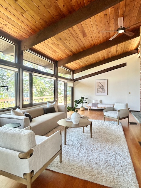 Staged interior of a coastal Rhode Island home with vaulted ceiling, light-filled layout, and neutral furnishings 