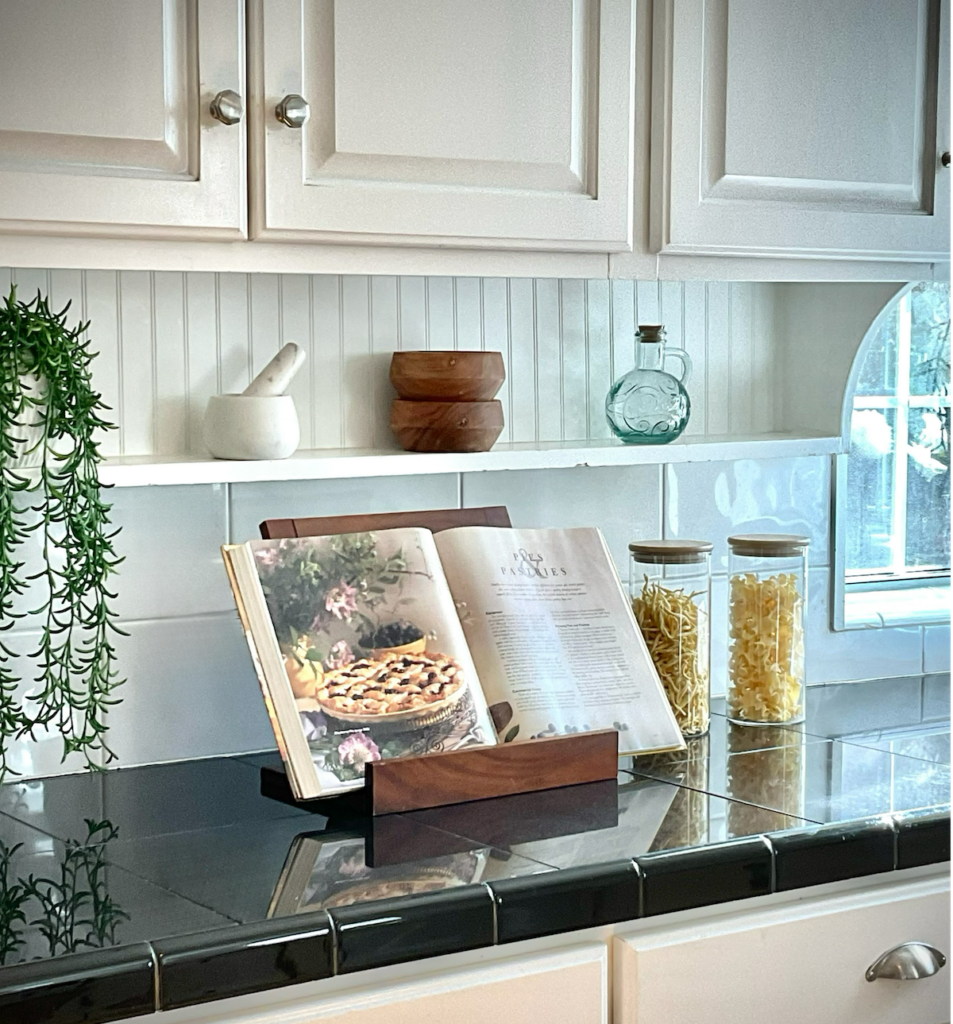 A kitchen styled with a cookbook and subtle lifestyle cues that suggest everyday use.