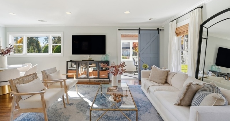 New Jersey home staging by CHC open-concept living room in Chatham Boro, New Jersey featuring neutral furnishings, natural light, and strategic furniture placement designed to help buyers better understand the layout and flow of the home