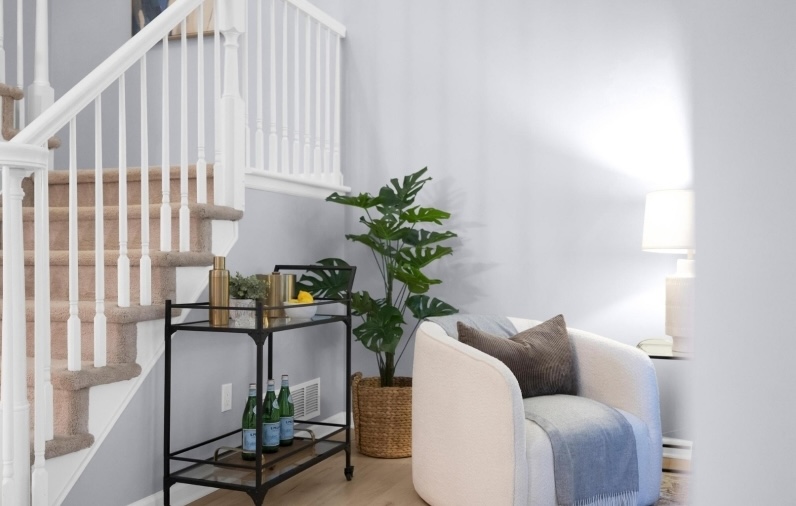 Professionally staged entryway by chc and staircase in Washington Township, New Jersey featuring modern accent furniture, soft neutral styling, and welcoming design details that enhanced the home's first impression for buyers.
