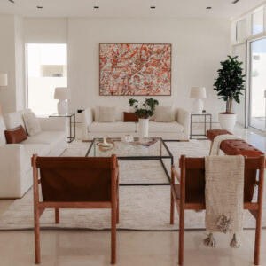 a staged property with a red painting above a white sofa, in the foreground is two trendy chairs and you can see a 2nd sofa off to the side. Dubai Real Estate MHY Homes RESA