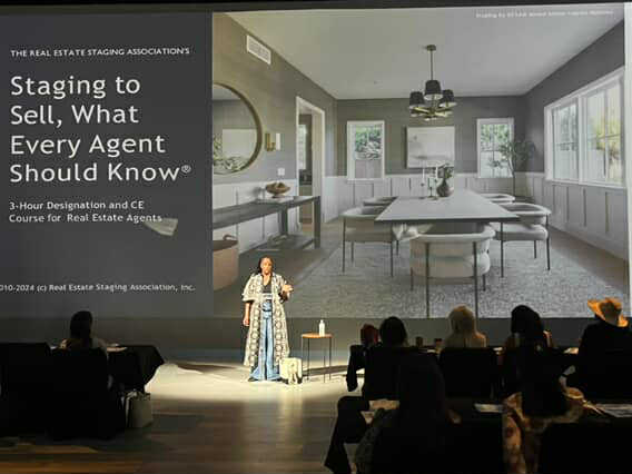 Kishah Langham teaches agents on stage at a RESA® event, demonstrating how to teach real estate agents about home staging through the CE course.
