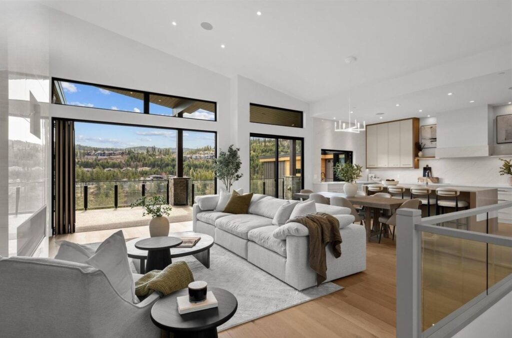 Luxury home staged by Tammy Cunningham of Center Stage Decorating, featuring a modern open-concept living room with panoramic windows and designer furnishings. Winner of the 2025 Home Staging Industry Award for Luxury Vacant Project – Canada.