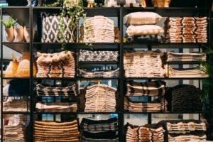 Home stager inventory neatly organized on black metal warehouse racks